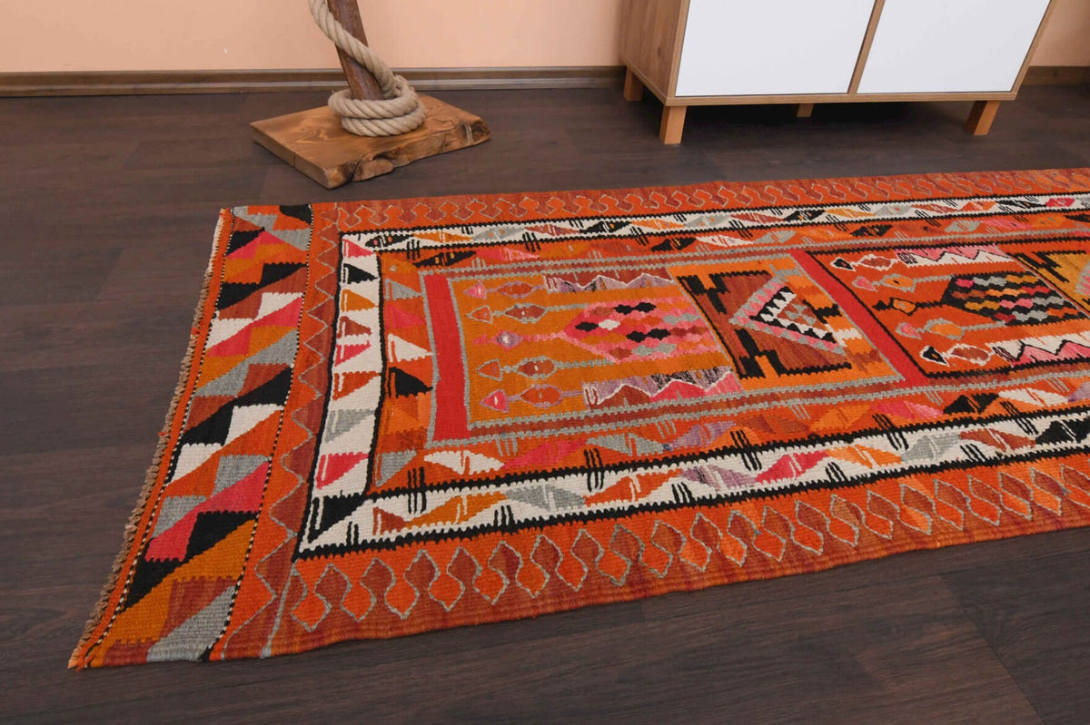 Ikat desenli vintage kilim yolluk – turuncu ve kırmızı tonlarda yün dokuma