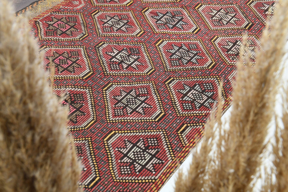 Ikat desenli el dokuma vintage kilim – turuncu, kırmızı ve pembe tonlarda yün dokuma