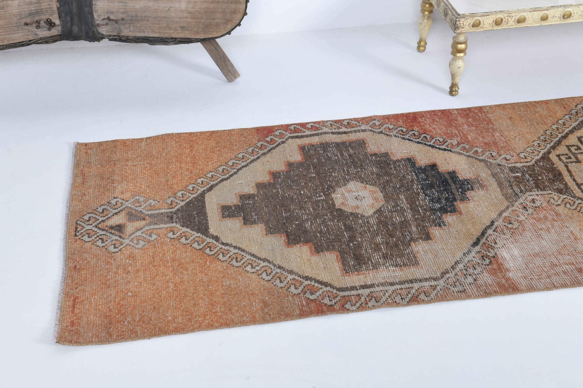 Geometrik desenli el dokuma vintage yolluk – turuncu ve kahverengi tonlarda yün dokuma